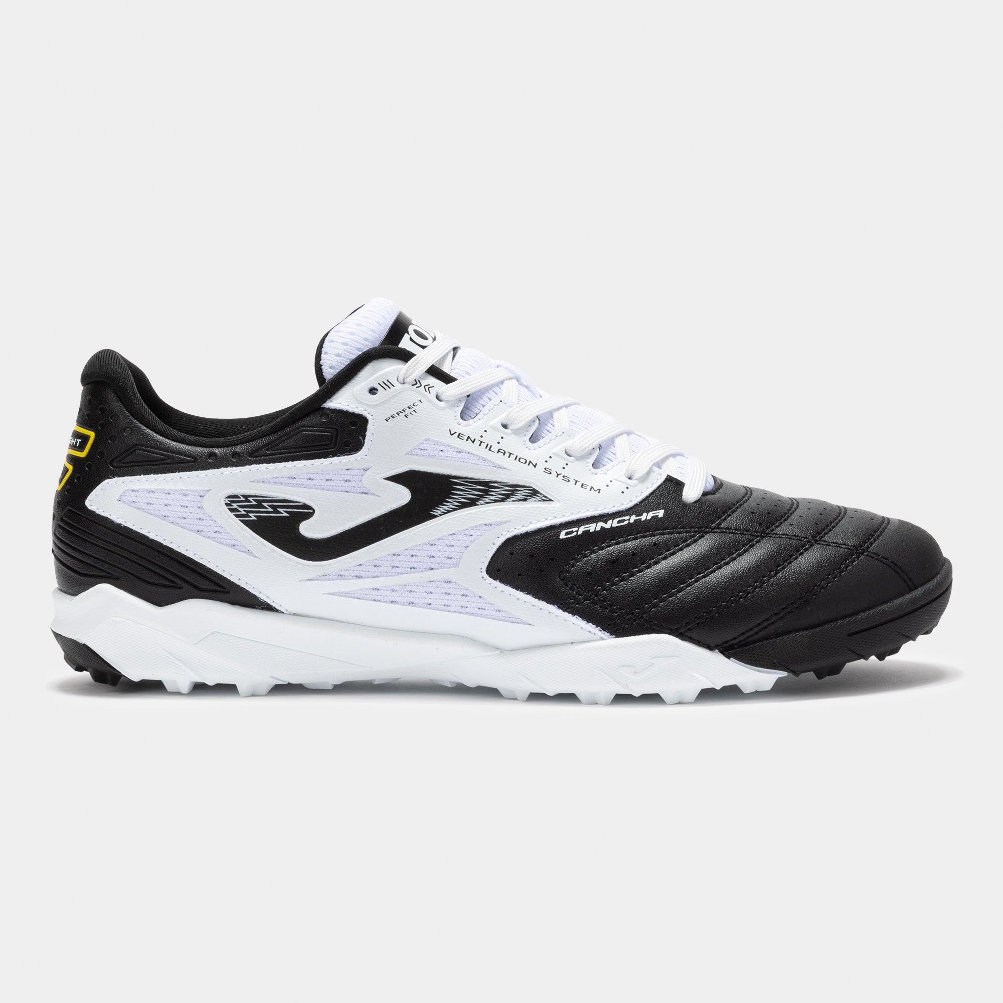 Joma Cancha 2501 turf soccer shoes in white – side view showing synthetic upper and turf outsole