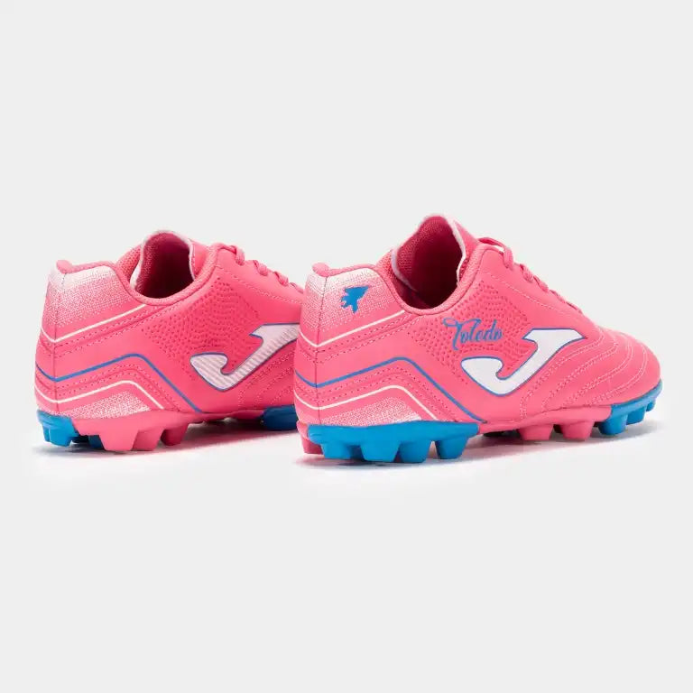 Pink soccer cleats with blue accents on a back view